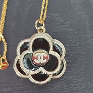 CHANEL Gold, Black And Ivory Zipper Pull.